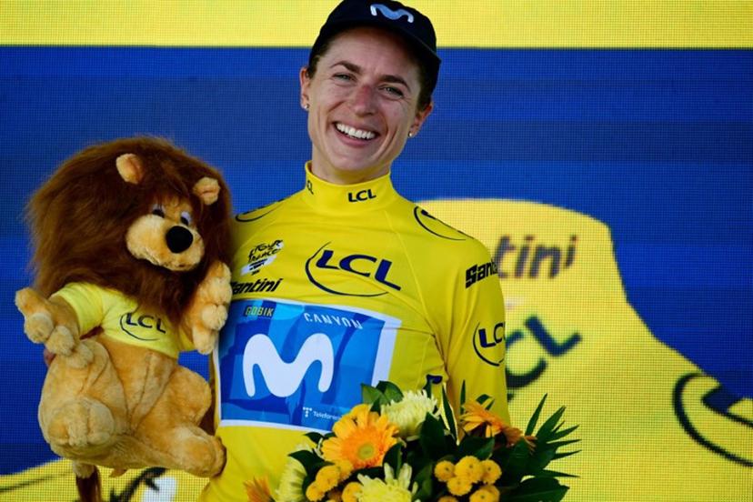 Movistar Team's Swiss rider Marlen Reusser poses on the podium with the overall leader's yellow jersey after placing second of the 5th (out of 9) stage of the fifth edition of the Women's Tour de France cycling race, 140 km from Macon to Belleville-en-Beaujolais, in Belleville-en-Beaujolais, central France on August 5, 2026.  NICOLAS TUCAT / AFP