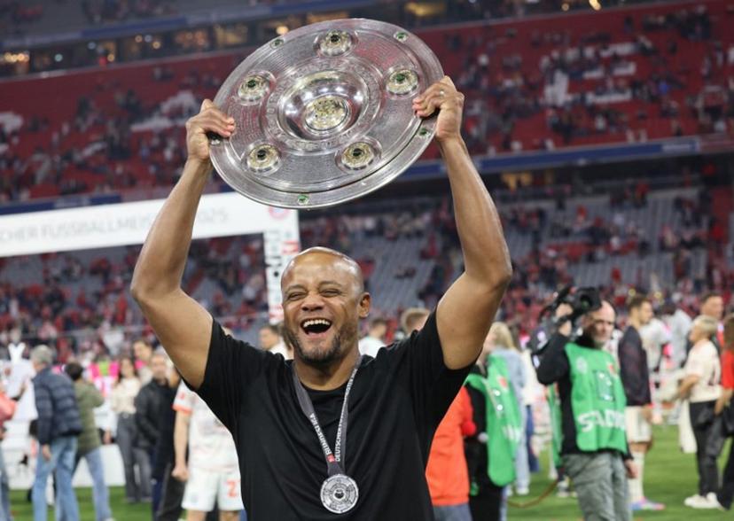 Bayern Munich's Belgian head coach Vincent Kompany celebrates with the trophy after the German first division Bundesliga football match between Bayern Munich and Borussia Moenchengladbach in Munich on May 10, 2025.  Alexandra BEIER / AFP