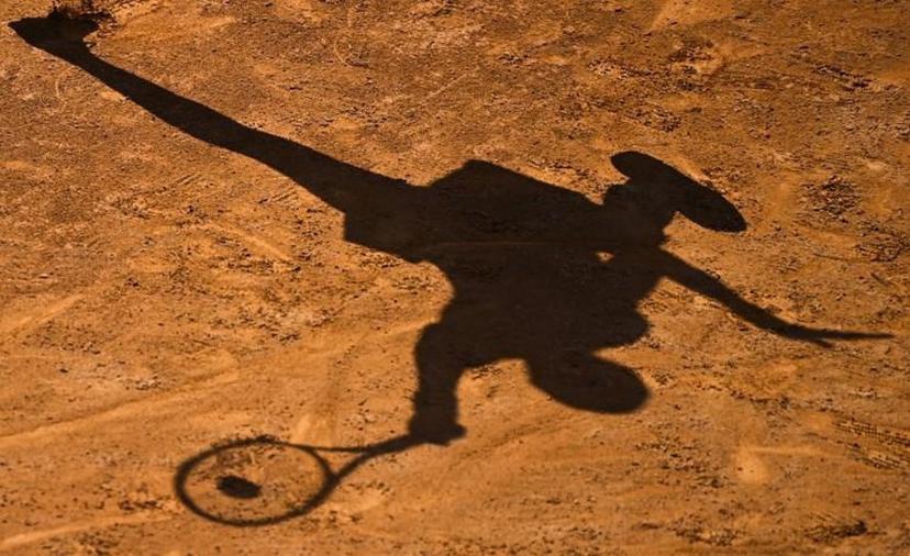The shadow of USA's Cori Gauff is cast on the clay as she plays a forehand to Spain's Garbine Muguruza on day four of the Women's Italian Open at Foro Italico on September 17, 2020 in Rome, Italy.  Riccardo Antimiani / POOL / AFP