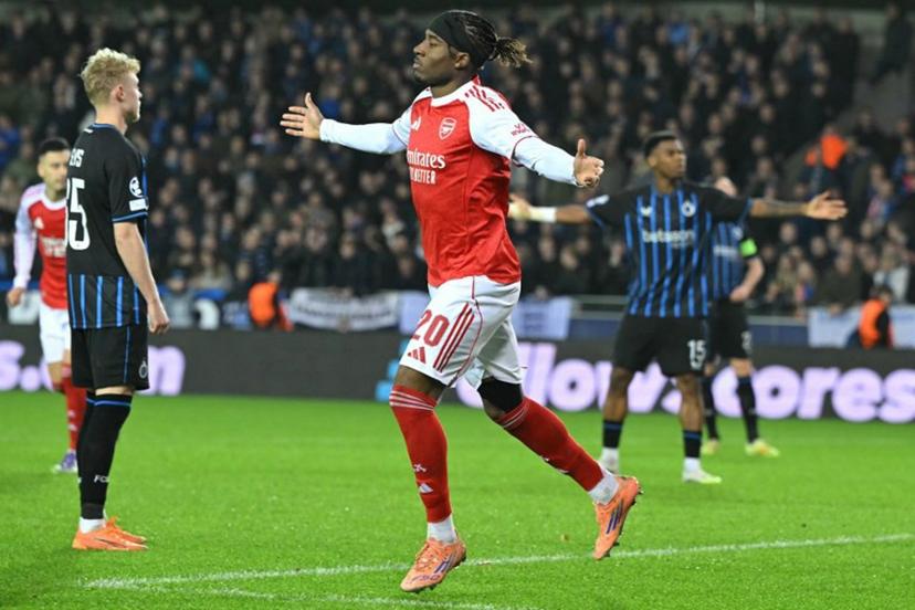 Arsenal's English forward #20 Noni Madueke (C) celebrates after scoring the Arsenal's second goal during the UEFA Champions League, league phase - matchday 6, football match between Club Brugge and Arsenal at the Jan Breydel stadium in Bruges on December 10, 2025.  NICOLAS TUCAT / AFP