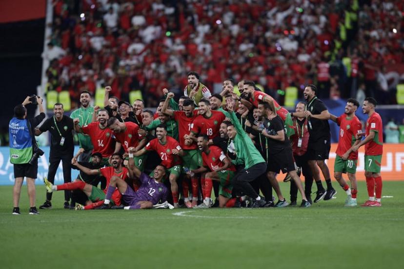 Morocco's players and staff pose for a photograph as they celebrate their win during the FIFA Arab Cup 2025 semi-final football match between Morocco and the United Arab Emirates at the Khalifa International Stadium in Al-Rayyan on December 15, 2025.  KARIM JAAFAR / AFP