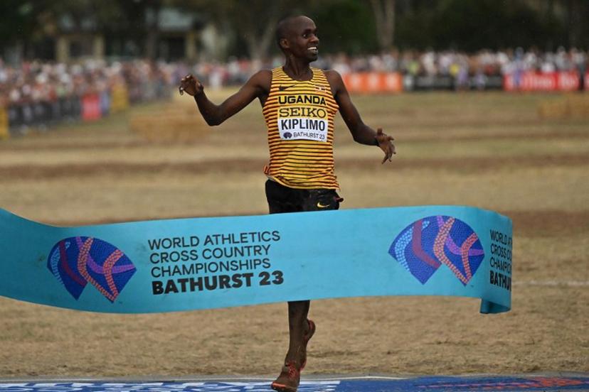 Uganda's Jacob Kiplimo celebrates as he crosses the finish line to win the men's senior race during the 2023 World Cross Country Championships at Mount Panorama in Bathurst on February 18, 2023.   Saeed KHAN / AFP