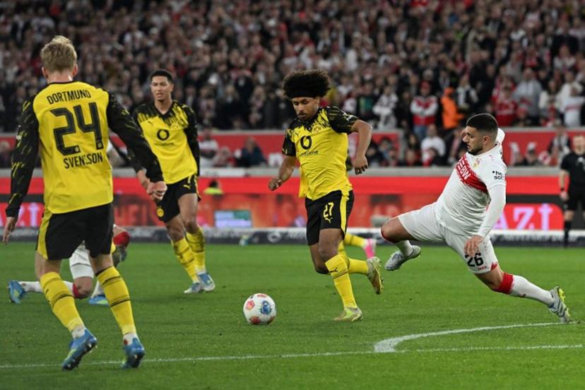 Stuttgart's German forward #26 Deniz Undav (R) and Dortmund's German forward #27 Karim Adeyemi vie for the ball during the German first division Bundesliga football match between VfB Stuttgart and BVB Borussia Dortmund in Stuttgart, southern Germany, on April 4, 2026.  THOMAS KIENZLE / AFP