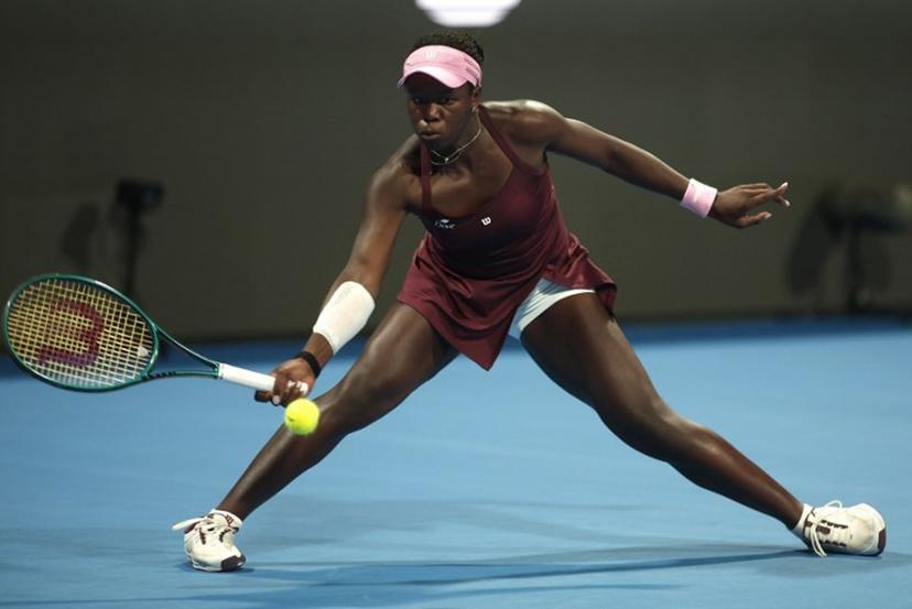 Canada's Victoria Mboko hits a return to Latvia's Jelena Ostapenko during their women's singles semi-final match at the Qatar Open tennis tournament in Doha on February 13, 2026.  Karim JAAFAR / AFP