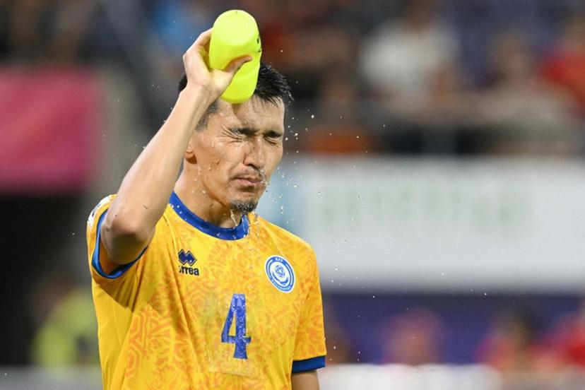 Kazakhstan's defender #04 Ular Zhaksybayev sprays water on his head during the FIFA World cup 2026 1st round day 6, Group J qualification football match between Belgium and Kazakhstan, at the Lotto Park stadium in Anderlecht, Brussels Capital Region, on September 7, 2025.  NICOLAS TUCAT / AFP