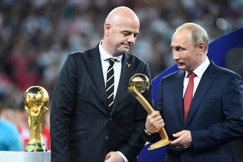 Russian President Vladimir Putin holds the adidas Golden Ball prize beside FIFA president Gianni Infantino (L) during the trophy ceremony at the end of the Russia 2018 World Cup final football match between France and Croatia at the Luzhniki Stadium in Moscow on July 15, 2018.  FRANCK FIFE / AFP RESTRICTED TO EDITORIAL USE - NO MOBILE PUSH ALERTS/DOWNLOADS

