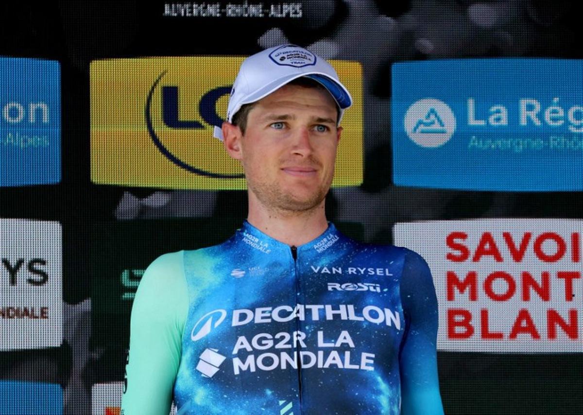 Team AG2R's French rider Nicolas Prodhomme celebrates on the podium after winning the day's most combative rider award of the third stage of the 76th edition of the Criterium du Dauphine cycling race, 181,7km between Celles-sur-Durolle and Les Estables, central France, on June 4, 2024.  Thomas SAMSON / AFP