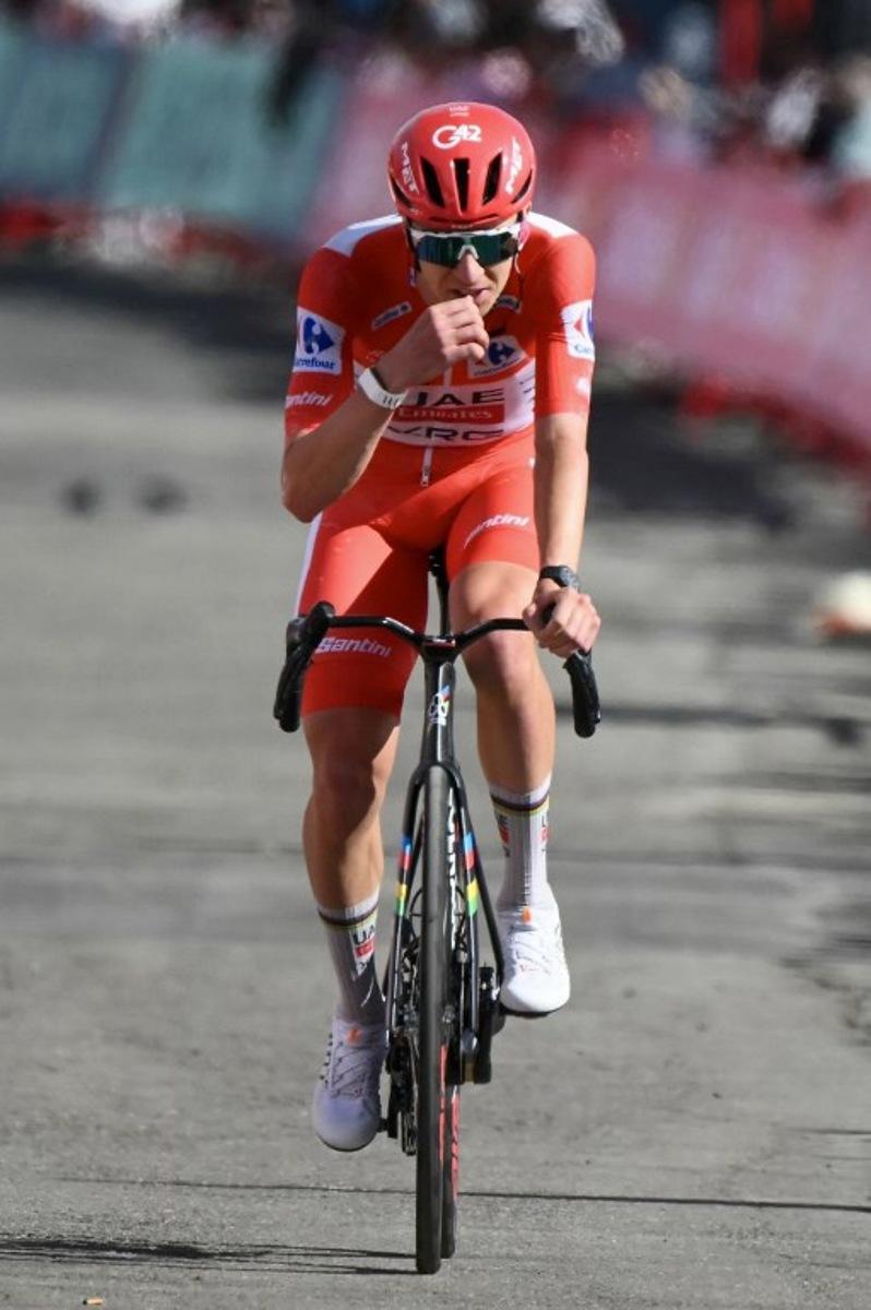 Team UAE's Slovenian rider Tadej Pogacar cycles during the seventh stage of the Vuelta a Espana 2026 on August 28, 2026.  Race leader Tadej Pogacar pulled out of the Vuelta a Espana on Saturday after a heavy fall 31km from the finish of a flat stage eight left him with shoulder and face injuries. Pogacar of Team UAE has won five Tour de France titles and a Giro d'Italia and was targetig his first overall victory on the Spanish 21-day race.  JOSE JORDAN / AFP