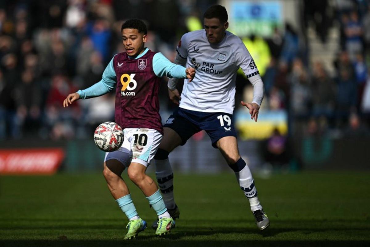 Burnley's Belgian midfielder #10 Manuel Benson battles for the ball with Preston's English defender #19 Lewis Gibson during the English FA Cup fifth round football match between Preston North End and Burnley at Deepdale stadium in Preston, north-west England on March 1, 2025.  Paul ELLIS / AFP