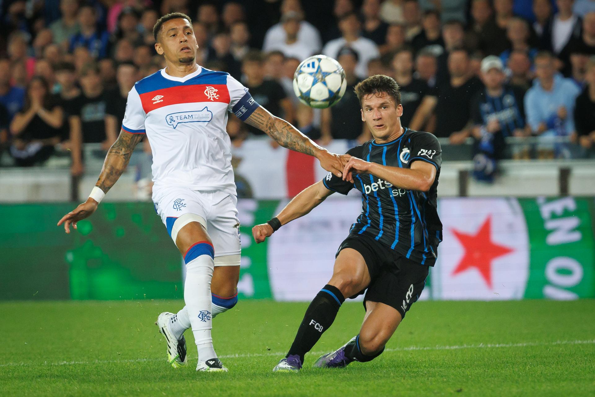 Rangers' James Tavernier and Club's Christos Tzolis fight for the ball during a soccer game between Belgian Club Brugge KV and Scottish Glasgow Rangers F.C., Wednesday 27 August 2025 in Brugge, the return leg of the play-offs for the Champions League tournament. Club won the first leg 1-3. BELGA PHOTO KURT DESPLENTER