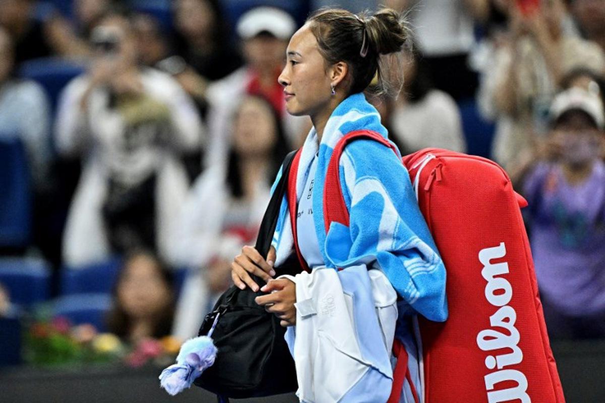 China's Zheng Qinwen leaves the court after retiring against Czech Republic's Linda Noskova during their women's singles match at the China Open tennis tournament in Beijing on September 29, 2025.  Pedro PARDO / AFP