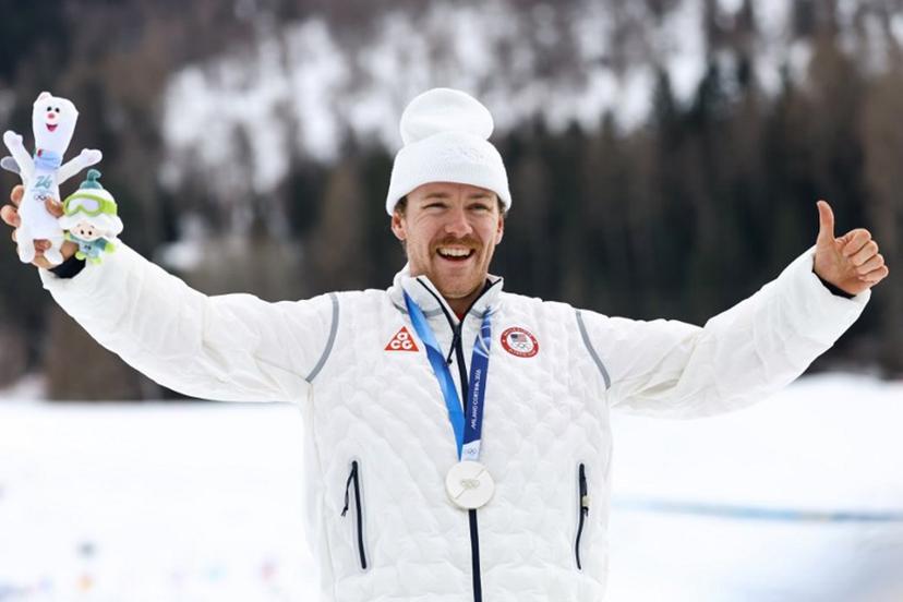 Silver medallist USA's Ben Ogden celebrates on the podium for the men's cross country sprint classic final event of the Milano Cortina 2026 Winter Olympic Games at Tesero Cross-Country Skiing Stadium in Lago di Tesero (Val di Fiemme), on February 10, 2026.  Anne-Christine POUJOULAT / AFP