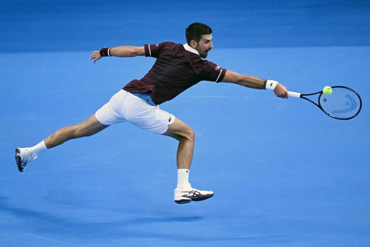 Serbia's Novak Djokovic hits a return to Russia's Daniil Medvedev during their men's singles semi-final match at the China Open tennis tournament in Beijing on October 5, 2026.  ADEK BERRY / AFP