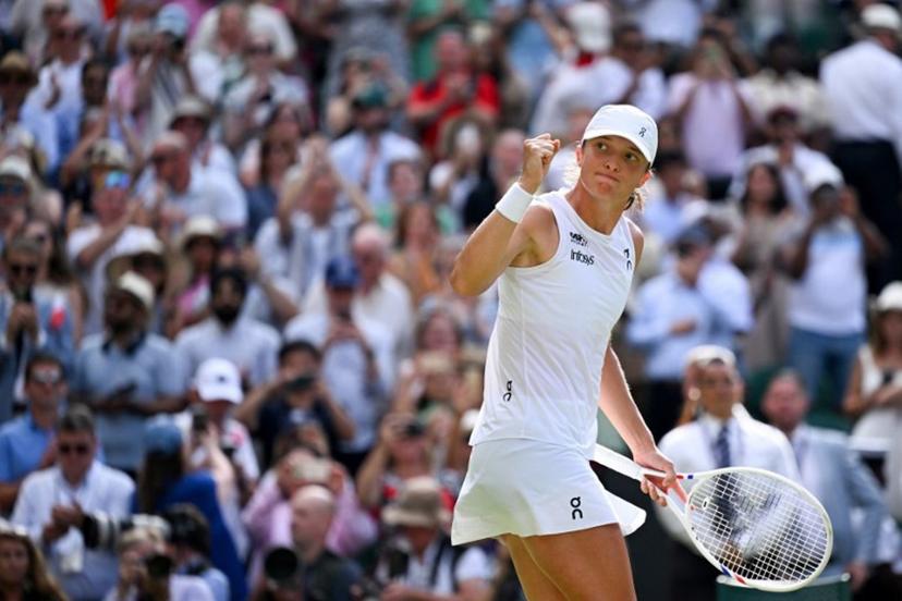Poland's Iga Swiatek celebrates after winning against US player Amanda Anisimova during their women's singles final tennis match on the thirteenth day of the 2025 Wimbledon Championships at The All England Lawn Tennis and Croquet Club in Wimbledon, southwest London, on July 12, 2025.  Kirill KUDRYAVTSEV / AFP