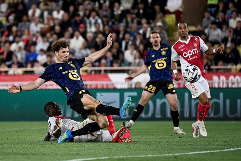 Lille's Belgian defender #12 Thomas Meunier (2nd L) kicks the ball to score a goal during the French L1 football match between Monaco (ASM) and Lille (LOSC) at the Louis II Stadium (Stade Louis II) in the Principality of Monaco on May 10, 2026.  Frederic DIDES / AFP