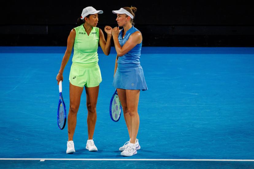 Belgium's Elise Mertens (blue) and Chinese Shuai Zhang (yellow) pictured during a tennis match between US pair Baptiste/Stearns and Belgian/ Chinese pair Mertens/Zhang, in the 1/8 final of the women doubles at the Australian Open, in Melbourne Park, Melbourne on Tuesday 27 January 2026.  BELGA PHOTO PATRICK HAMILTON  --- BENELUX ONLY   ---