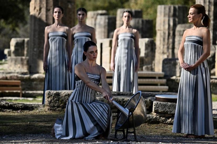 Greek actress Mary Mina (C), playing the role of the High Priestess, participates in a rehearsal of the lighting of the Olympic flame for the Milano-Cortina 2026 Winter Olympic Games, in the ancient Temple of Hera at the archaeological site of Olympia, birthplace of the ancient Olympics in southern Greece, on November 24, 2025.  Aris MESSINIS / AFP