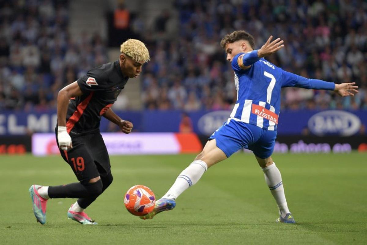 Barcelona's Spanish forward #19 Lamine Yamal (L) vies for the ball with Espanyol's Spanish forward #07 Javier Puado during the Spanish league football match between RCD Espanyol and FC Barcelona at the RCDE Stadium in Cornella de Llobregat, on May 15, 2025.  MANAURE QUINTERO / AFP