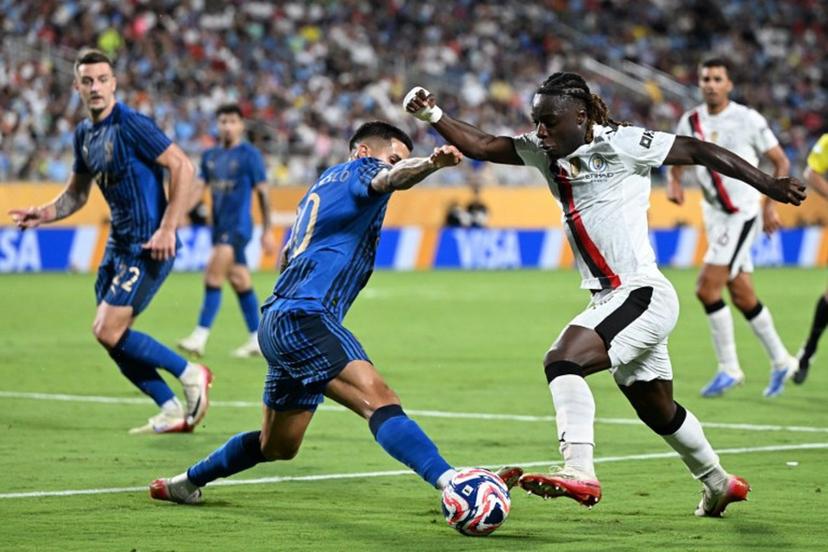 Al Hilal's Portuguese defender #20 Joao Cancelo and Manchester City's Belgian midfielder #11 Jeremy Doku fight for the ball during the FIFA Club World Cup 2025 round of 16 football match between England's Manchester City and Saudi's Al-Hilal at the Camping World stadium in Orlando on June 30, 2025.  PATRICIA DE MELO MOREIRA / AFP