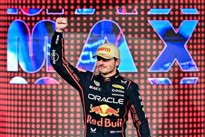 Race winner Red Bull Racing's Dutch driver Max Verstappen celebrates on the podium at the end of the Abu Dhabi Formula One Grand Prix at the Yas Marina Circuit in Abu Dhabi on December 7, 2025.  Giuseppe CACACE / AFP
