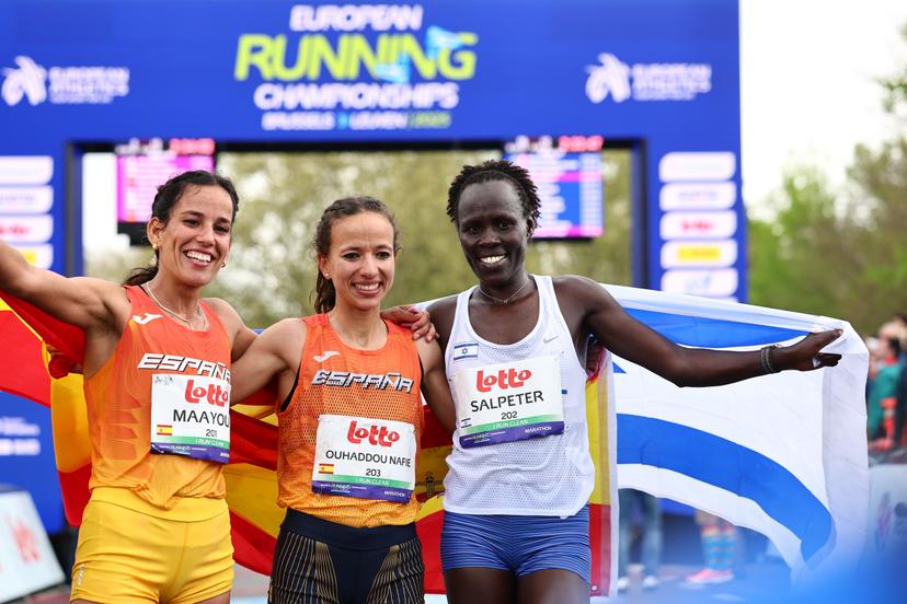 L-R, second Spanish Maayouf Majida, winner Spanish Fatima Ouhaddou and third Israelian Lonah Salpeter celebrate after the women marathon race at European Running Championships, from Leuven to Brussels, Sunday 13 April 2025.  BELGA PHOTO DAVID PINTENS