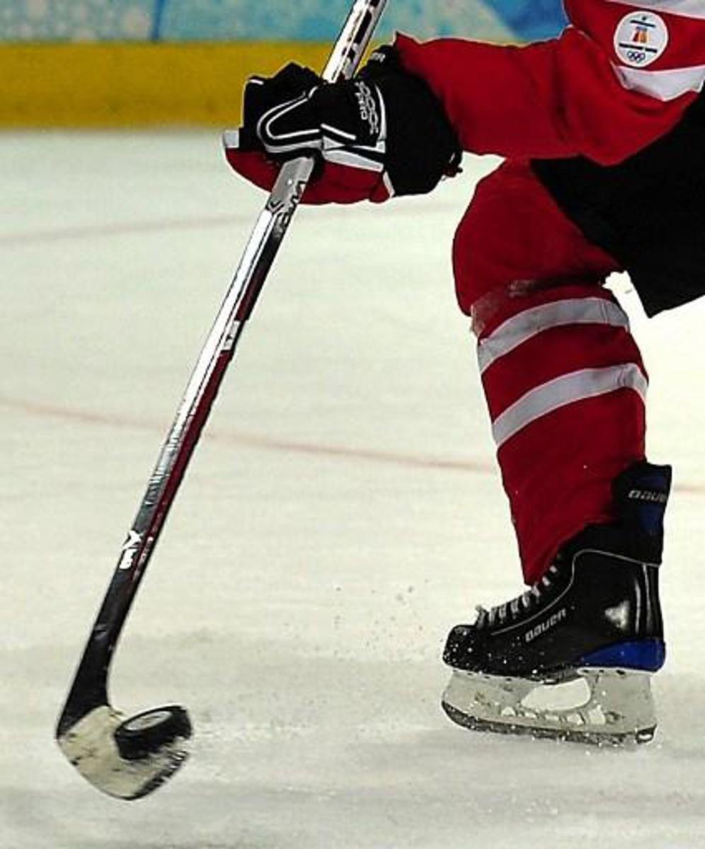 A Canadian player stick handles the puck during the Women's Ice Hockey preliminary game between Switzerland  and Canada at the UBC Thunderbird Arena  during the XXI Winter Olympic Games in Vancouver, Canada on February 15, 2010. AFP PHOTO/Luis ACOSTA