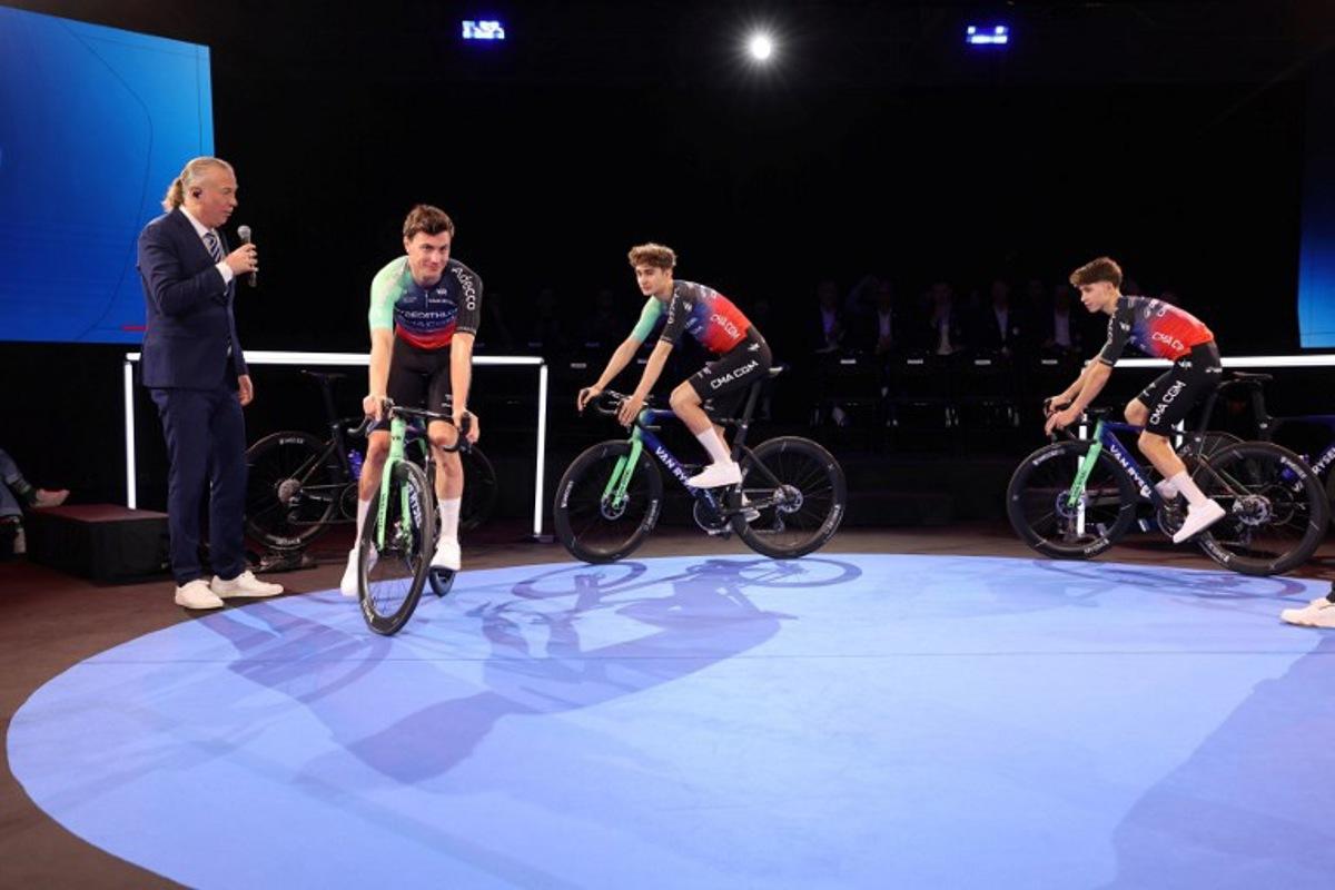 (From 2L) Decathlon-CMA CGM's Dutch cyclist Olav Kooij, French rider Paul Seixas and French rider Antoine L'Hote attend the presentation of the new Decathlon CMA-GGM cycling team at the Decathlon Campus in Villeneuve-d'Ascq, northern France on December 11, 2025.  Francois LO PRESTI / AFP