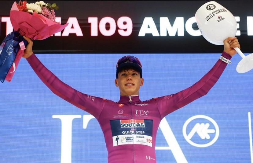 Soudal Quick-Step French rider Paul Magnier wearing the points classification mauve jersey (Maglia Ciclamino) celebrates on the podium after the 2nd stage of the Giro d'Italia 2026 - Tour of Italy cycling race between Burgas and Veliko Tarnovo, Bulgaria, on May 9, 2026.  Luca Bettini / AFP