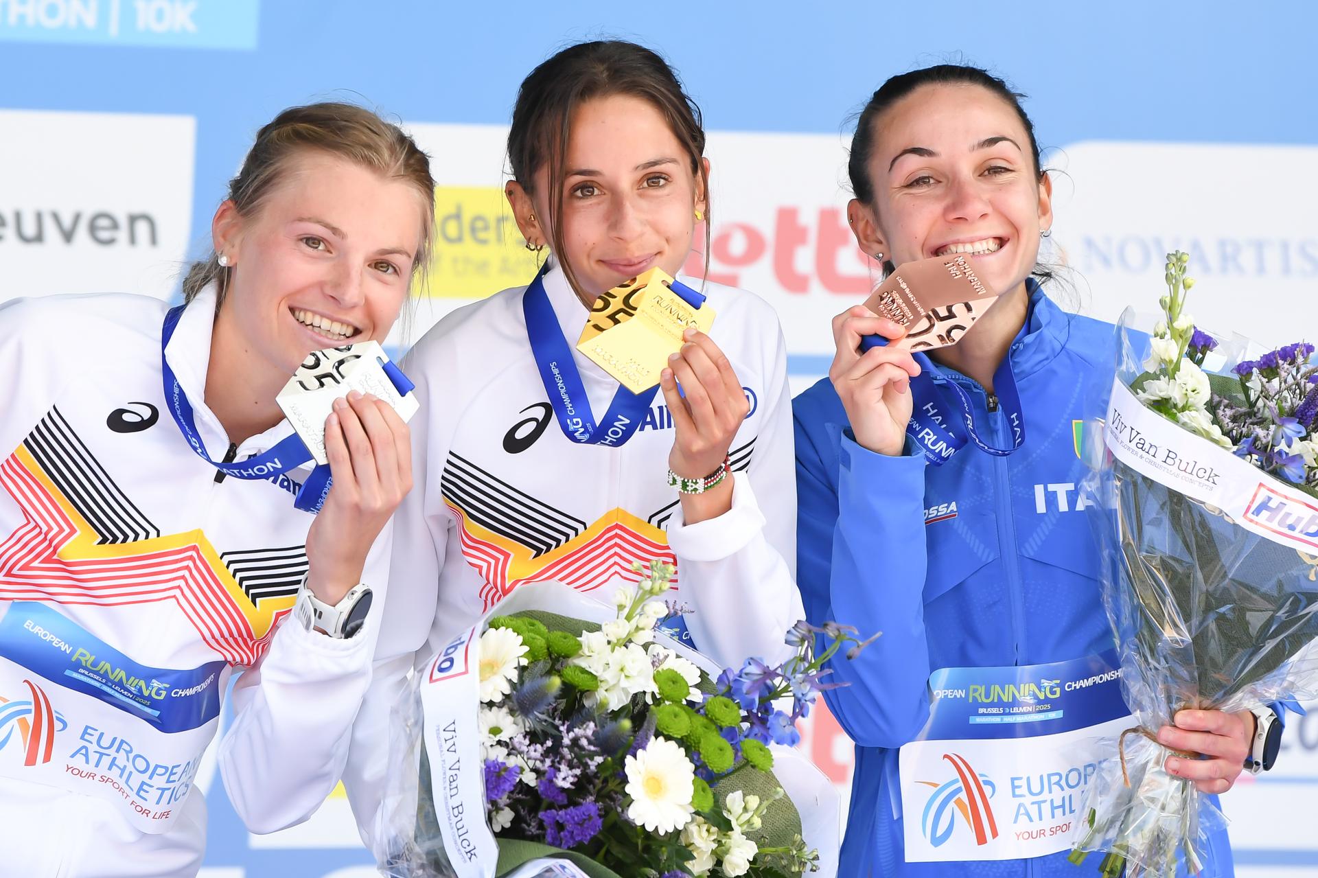 Belgian Juliette Thomas, Belgian Chloe Herbiet and Italian Sara Nestola pictured on the podium after the half marathon race at European Running Championships, in Leuven, Saturday 12 April 2025. BELGA PHOTO JILL DELSAUX