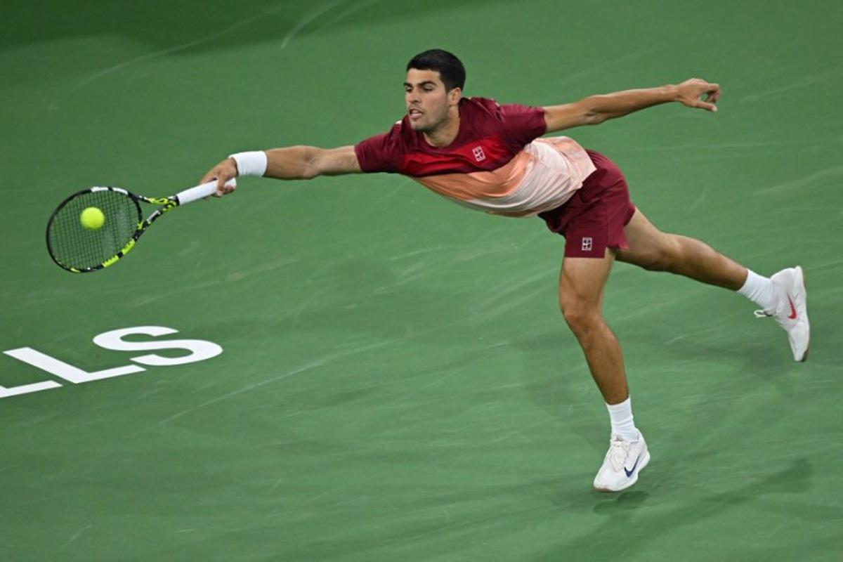 Spain's Carlos Alcaraz hits a return during his men's singles quarter-final tennis match against Argentina's Francisco Cerundolo at the BNP Paribas Open at the Indian Wells Tennis Garden in Indian Wells, California, on March 13, 2025.  Patrick T. Fallon / AFP