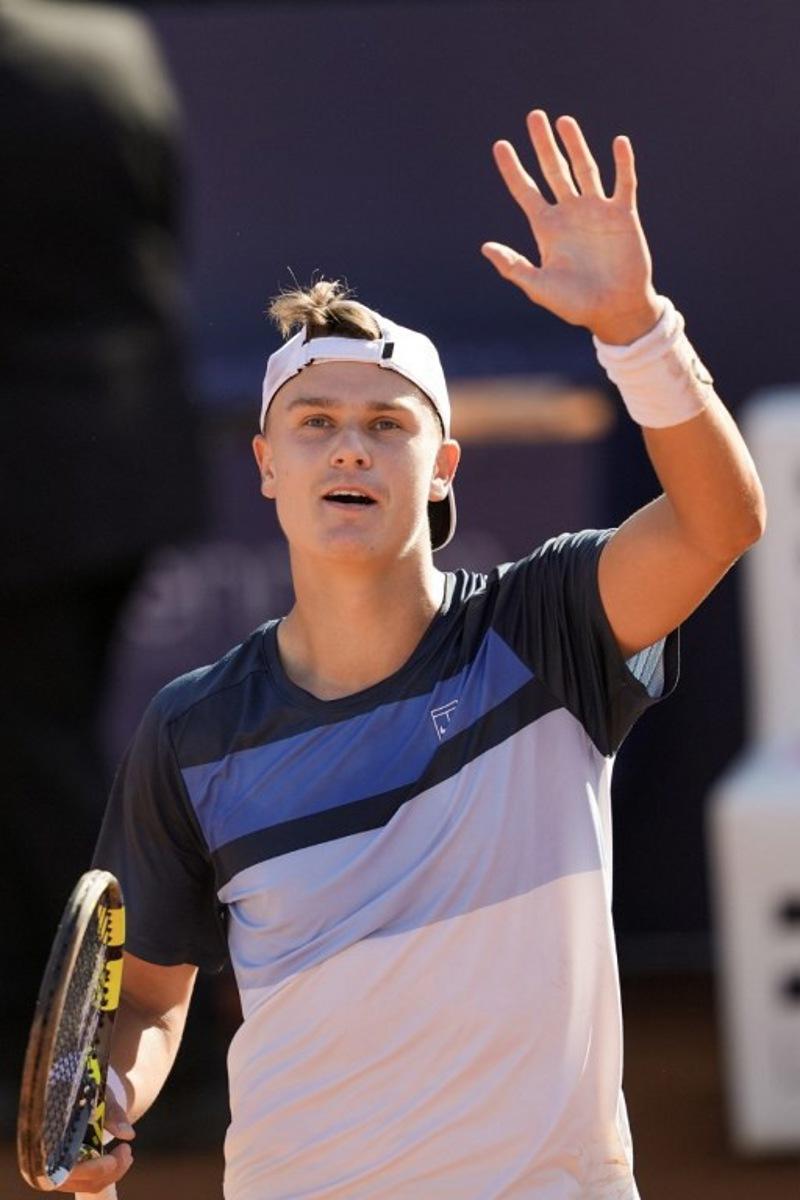 Denmark's Holger Rune celebrates winning against Spain's Carlos Alcaraz in the ATP Barcelona Open "Conde de Godo" tennis tournament singles final match at the Real Club de Tenis in Barcelona, on April 20, 2025. Rune won 7-6 6-2. MANAURE QUINTERO / AFP