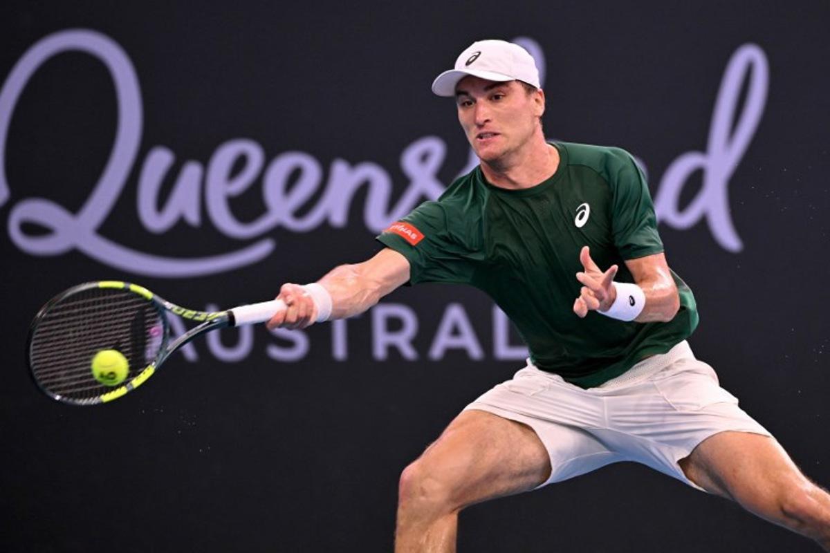 Raphael Collignon of Belgium hits a return during his men's singles match against Brandon Nakashima of the US at the Brisbane International tennis tournament in Brisbane on January 9, 2026.  William WEST / AFP