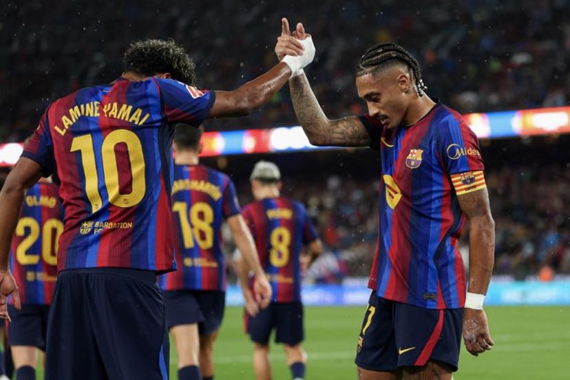 Barcelona's Brazilian forward #11 Raphinha celebrates scoring his team's second goal from the penalty spot with Barcelona's Spanish forward #10 Lamine Yamal during the Spanish league football match between FC Barcelona and Racing Santander at the Camp Nou stadium in Barcelona on September 16, 2026.  Lluis GENE / AFP