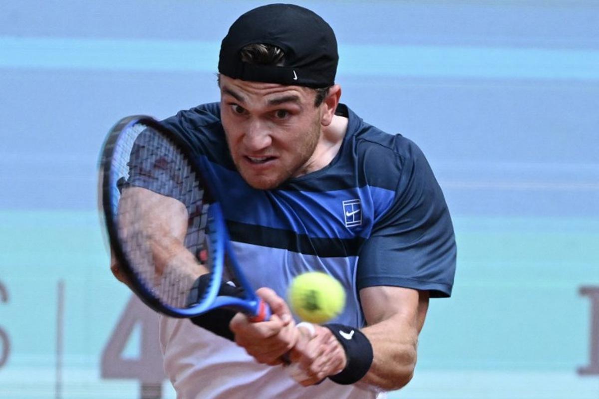 Great Britain's Jack Draper returns a backhand to Italy's Matteo Arnaldi during their 2025 ATP Tour Madrid Open tennis tournament quarter-final singles match at the Caja Magica in Madrid, on May 1, 2025.  JAVIER SORIANO / AFP