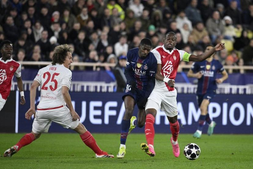 Paris Saint-Germain's French forward #10 Ousmane Dembele (C) and Monaco's Swiss midfielder #06 Denis Zakaria (R) fight for the ball during the UEFA Champions League knockout round play-off first leg football match between AS Monaco and Paris Saint-Germain at the Stade Louis II in the Principality of Monaco on February 17, 2026.  FREDERIC DIDES / AFP