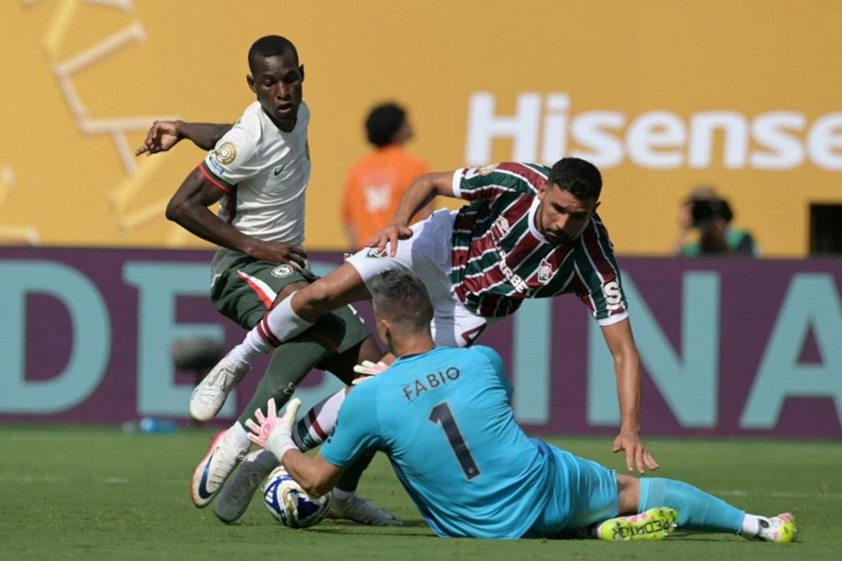 Chelsea's Senegalese striker #15 Nicolas Jackson fights for the ball with Fluminense's Brazilian defender #04 Ignacio and Brazilian goalkeeper #01 Fabio during the FIFA Club World Cup 2025 semifinal football match between Brazil's Fluminense and England's Chelsea at the MetLife stadium in East Rutherford, New Jersey on July 8, 2025.  JUAN MABROMATA / AFP