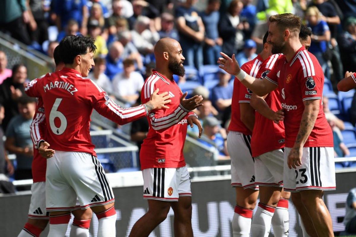 Manchester United's Cameroonian midfielder #19 Bryan Mbeumo (C) celebrates scoring the team's first goal during the English Premier League football match between Everton and Manchester United at Hill Dickinson Stadium in Liverpool, north-west England on September 6, 2026.  PETER POWELL / AFP