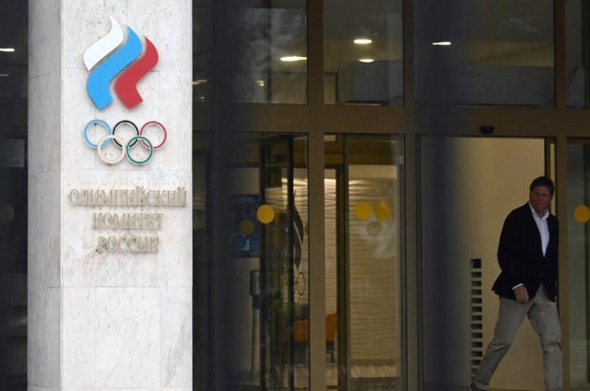 A man walks past the logo of the Russian Olympic Committee (ROC) as he leaves the office in Moscow on October 15, 2024. The head of Russia's Olympic Committee announced his resignation on October 15, 2024, a surprise move that comes as Moscow faces isolation from international sport over its Ukraine offensive. Former fencer, Stanislav Pozdnyakov, a five-time Olympic medallist, said in his resignation letter there were "timely" reasons why Russian sport needed a new leader, without going into detail. Natalia KOLESNIKOVA / AFP