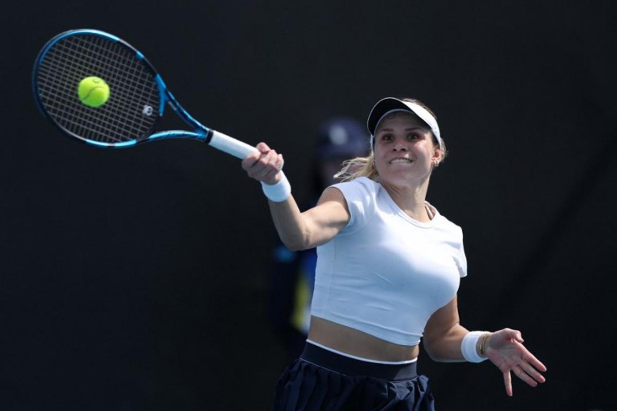 Croatia's Jana Fett hits a return against Britain's Harriet Dart during their women's singles match on day two of the Australian Open tennis tournament in Melbourne on January 13, 2025.  Adrian Dennis / AFP