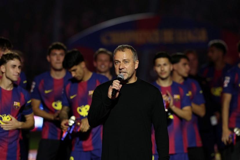 Barcelona's German coach Hans-Dieter Flick speaks as Barcelona's players celebrate winning the 2025-2026 Spanish League after the Spanish league football match between FC Barcelona and Real Madrid CF at Camp Nou Stadium in Barcelona on May 10, 2026.  Lluis GENE / AFP
