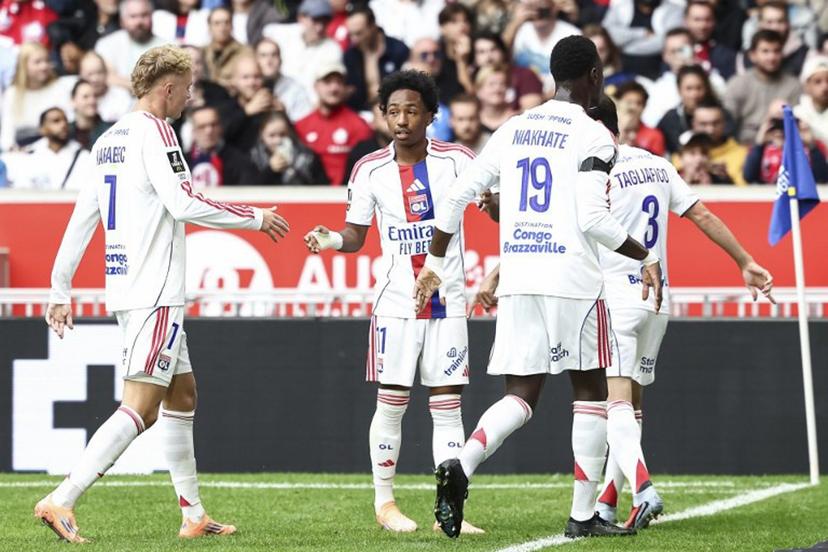 Lyon's players celebrate their team's first goal during the French L1 football match between Lille LOSC and Olympique Lyonnais (OL) at the Stade Pierre-Mauroy in Villeneuve-d'Ascq, northern France, on September 28, 2025.  Sameer Al-DOUMY / AFP