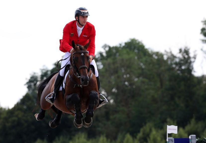 Germany's Richard Vogel with horse United Touch S competes in the equestrian's jumping team qualifier during the Paris 2024 Olympic Games at the Chateau de Versailles, in Versailles, in the western outskirts of Paris, on August 1, 2024.  Pierre-Philippe MARCOU / AFP