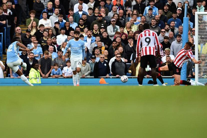 Manchester City's Ghanaian midfielder #42 Antoine Semenyo (L) shoots to score their third goal during the English Premier League football match between Manchester City and Sunderland at the Etihad Stadium in Manchester, north west England, on September 20, 2026.  PETER POWELL / AFP