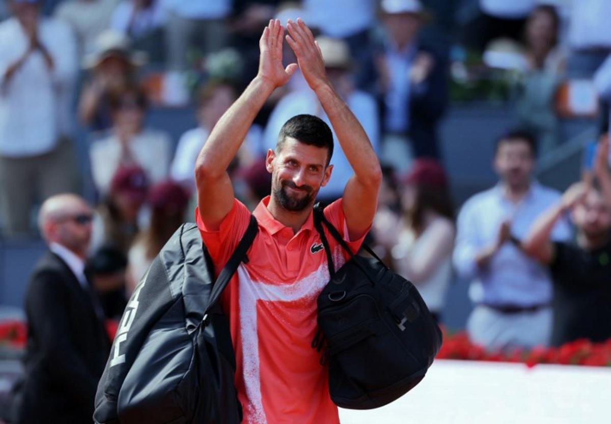 Serbia's Novak Djokovic waves after losing against Italy's Matteo Arnaldi  at the end of their 2025 ATP Tour Madrid Open tennis tournament second round singles match at the Caja Magica in Madrid, on April 26, 2025.  Thomas COEX / AFP