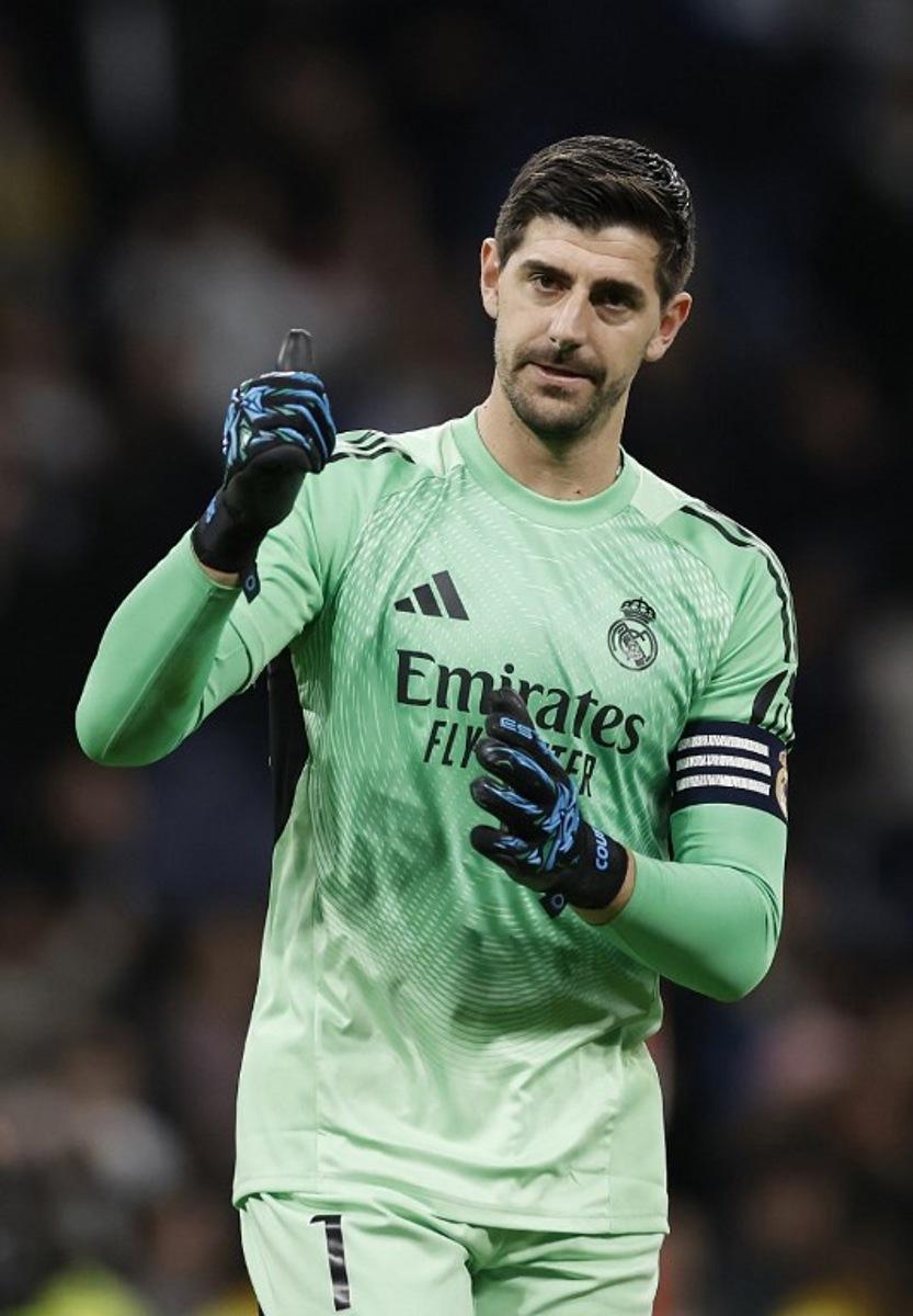 Real Madrid's Belgian goalkeeper #01 Thibaut Courtois celebrates at the end of the Spanish league football match between Real Madrid CF and Sevilla FC at Santiago Bernabeu Stadium in Madrid on December 20, 2025.  Oscar DEL POZO / AFP