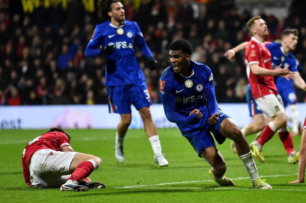 Chelsea's English defender #34 Josh-Kofi Acheampong celebrates scoring the team's second goal during the English FA Cup fifth round football match between Wrexham and Chelsea at the Racecourse Ground Stadium in Wrexham, north Wales, on March 7, 2026.  PETER POWELL / AFP