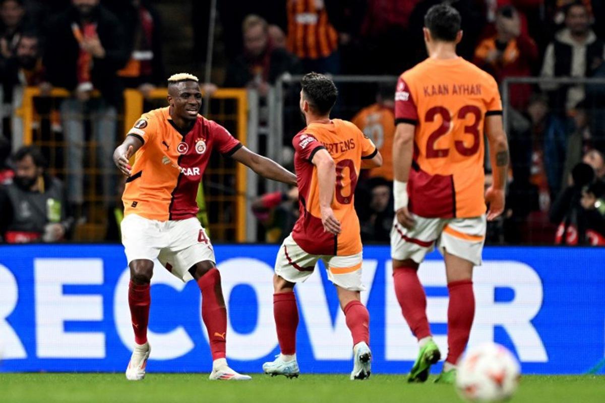 Galatasary's Nigerian forward #45 Victor Osimhen (L) celebrates with Galatasaray's Belgian forward #10 Dries Mertens (C) after scoring a goal during the UEFA Europa League, League phase - Matchday 4, football match between Galatasaray and Tottenham at the Ali Sami Yen Spor Kompleksi in Istanbul on November 7, 2024.  Ozan KOSE / AFP