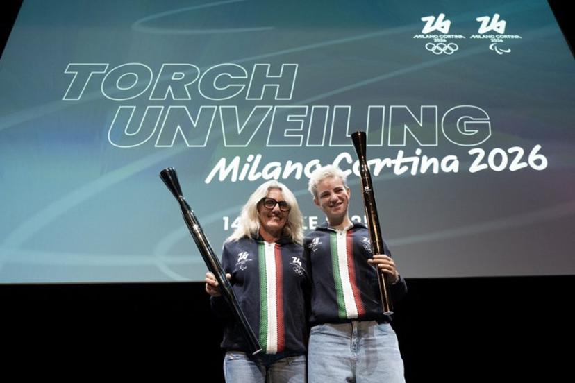 Former cross-country Italian athlete Stefania Belmondo and fencing paralympic champion Bebe Vio (R) pose during the unveiling of the torches for the Milano Cortina 2026 winter olympic and paralympic games in Milan on April 14, 2025.   MARCO BERTORELLO / AFP