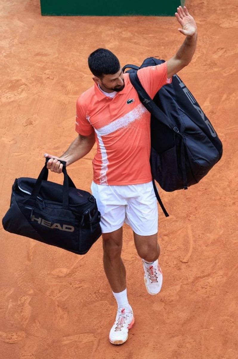 Serbia's Novak Djokovic leaves the court after losing against Chile's Alejandro Tabilo during the Monte Carlo ATP Masters Series Tournament round of 32 tennis match on the Rainier III court at the Monte Carlo Country Club in Roquebrune-Cap-Martin on April 9, 2025.  Valery HACHE / AFP