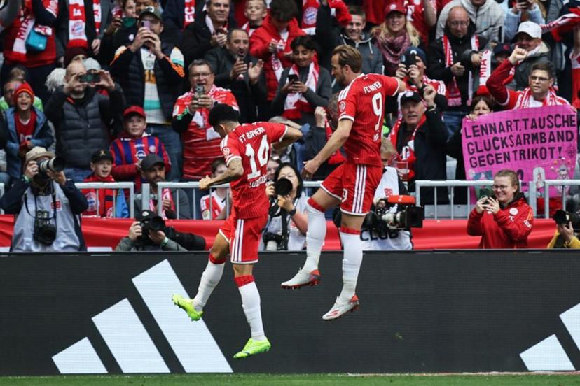 Bayern Munich's English forward #09 Harry Kane (R) jumps to celebrate scoring the opening 1-0 goal during the German first division Bundesliga football match between FC Bayern Munich and FC Cologne in Munich, southern Germany, on May 16, 2026.  Alexandra BEIER / AFP